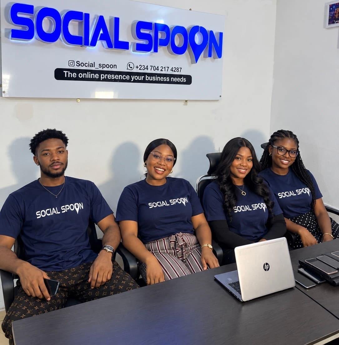 The Social Spoon team in the studio, wearing branded shirts in front of the company sign